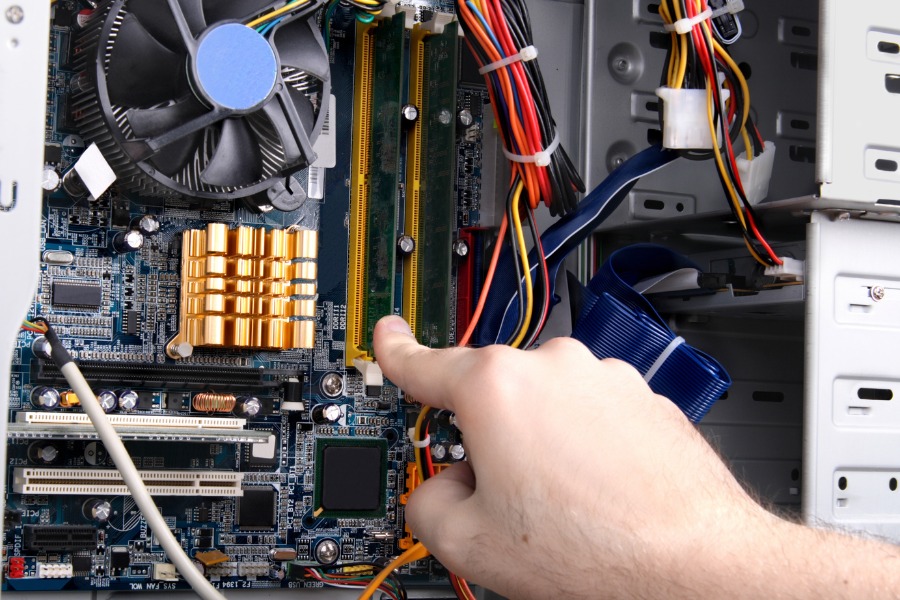 A hand inside an electrical panel.